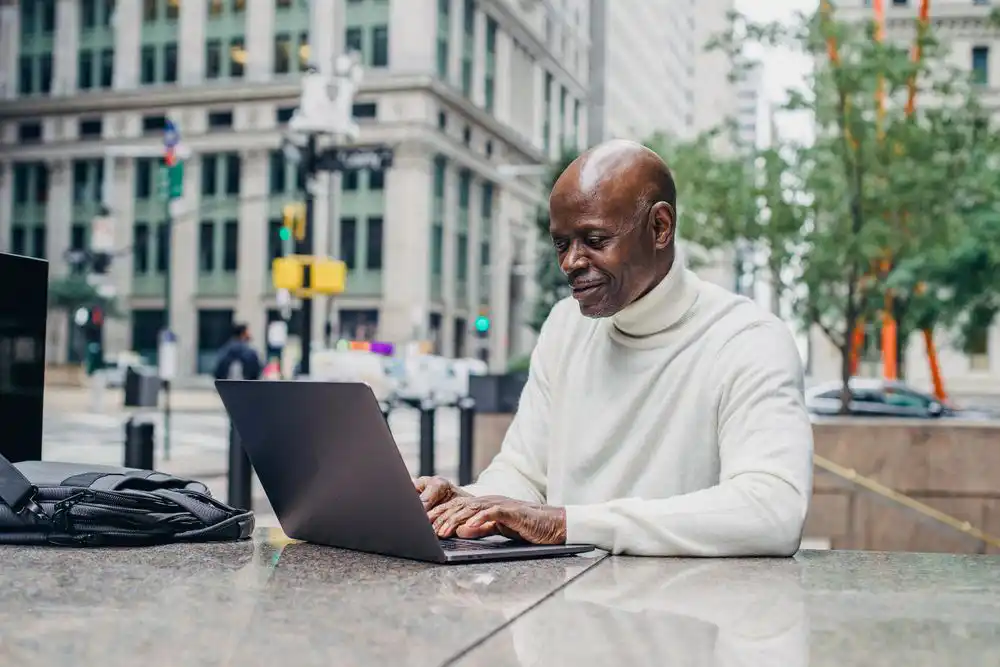 A gentlemen working on a laptop